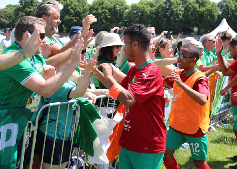 Footballers high-fiving fans