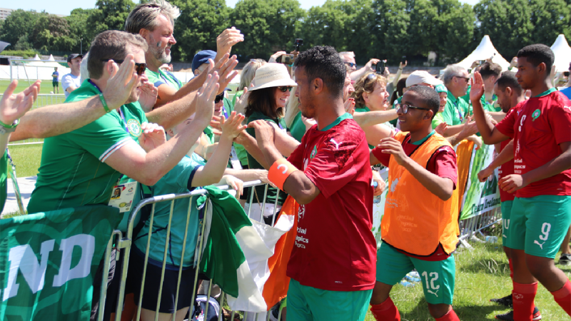 Footballers high-fiving fans