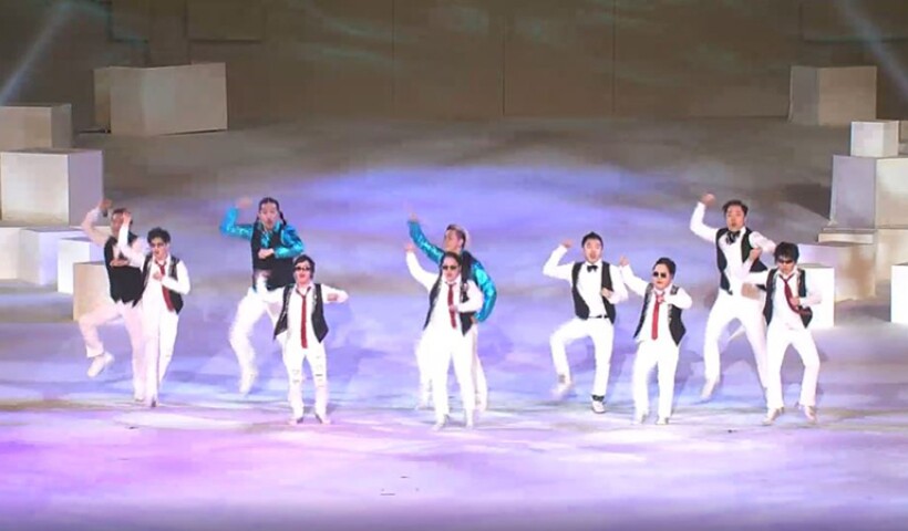 10 dancers performing on stage. 