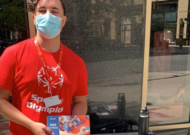 A canvasser holding Special Olympics materials.