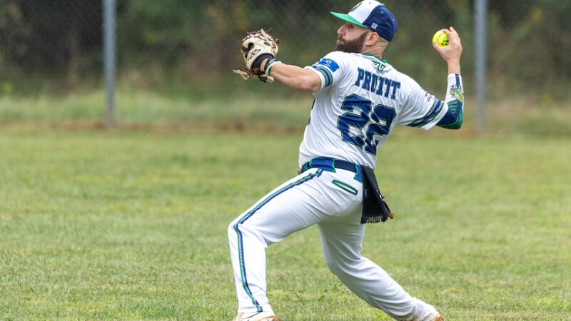 A softball player prepares to throw the ball. 