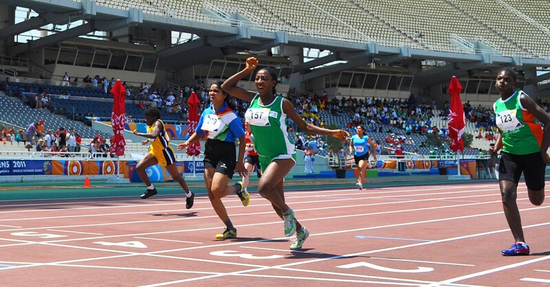 6 runners on the track racing. 