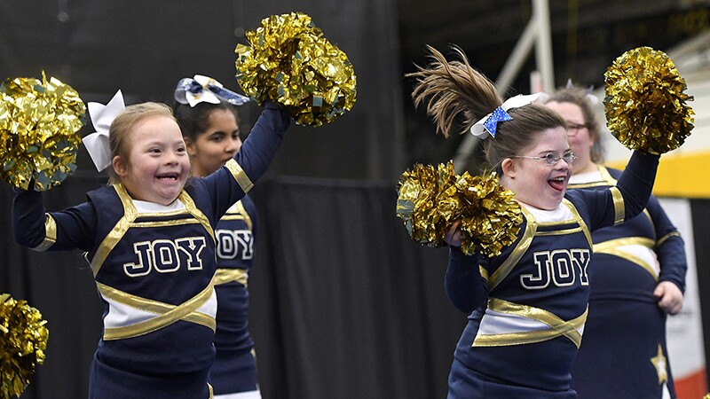 A group of four girls performing a cheer. 