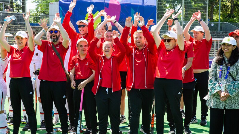 A group of athletes cheering. 