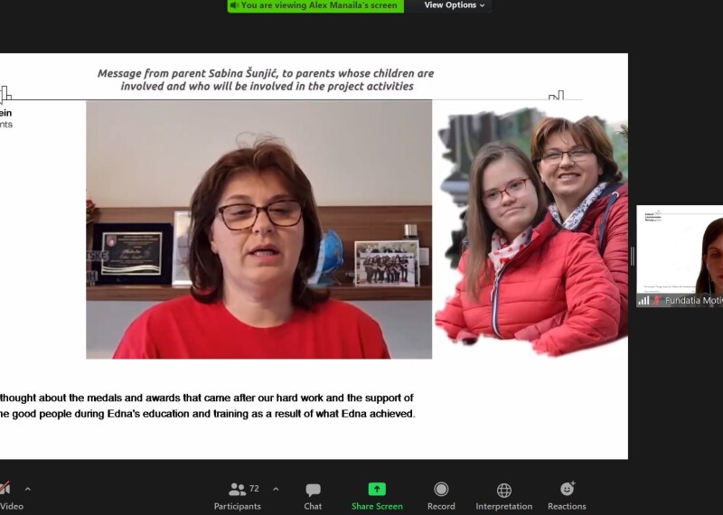 A screenshot of a Zoom meeting featuring a woman in a red t-shirt facing the camera, a photo of the woman with a younger woman.