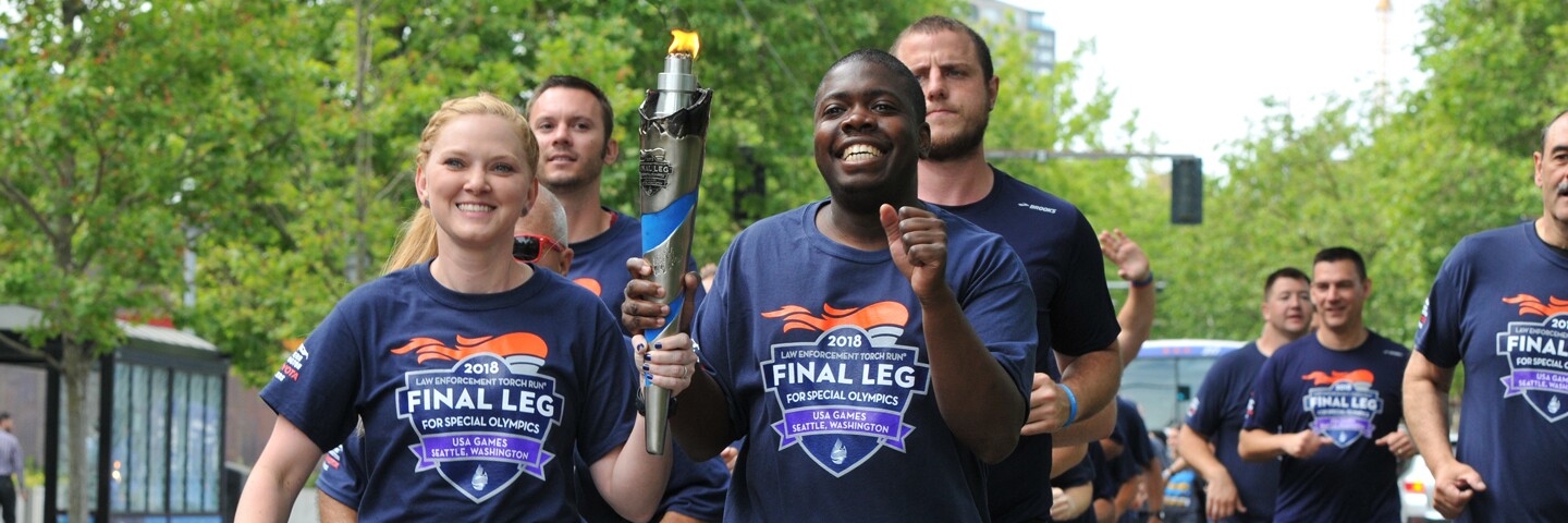 Group of runners running and holding the flame of hope. 