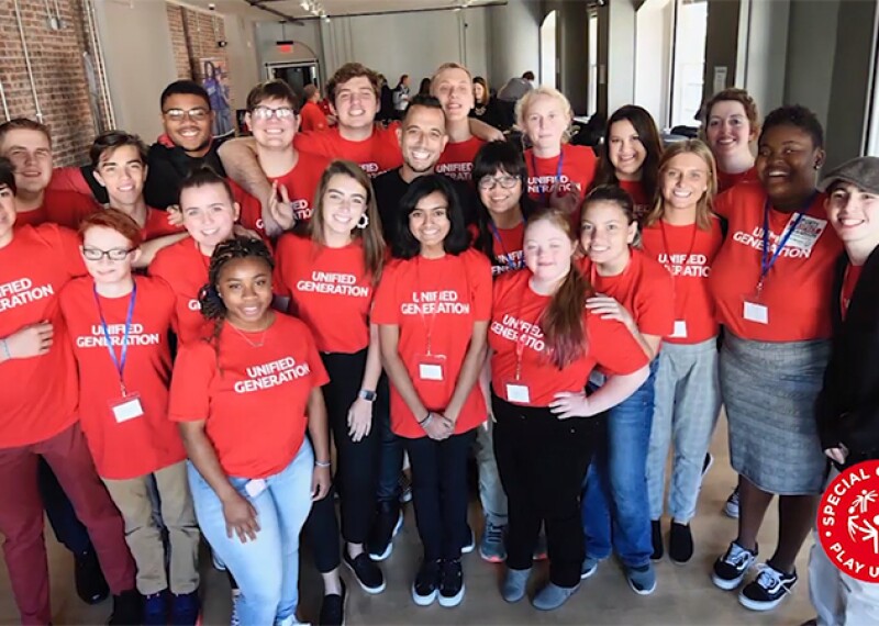 Unified group standing together for a group photo. 