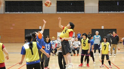 Girls playing basketball on a court. 