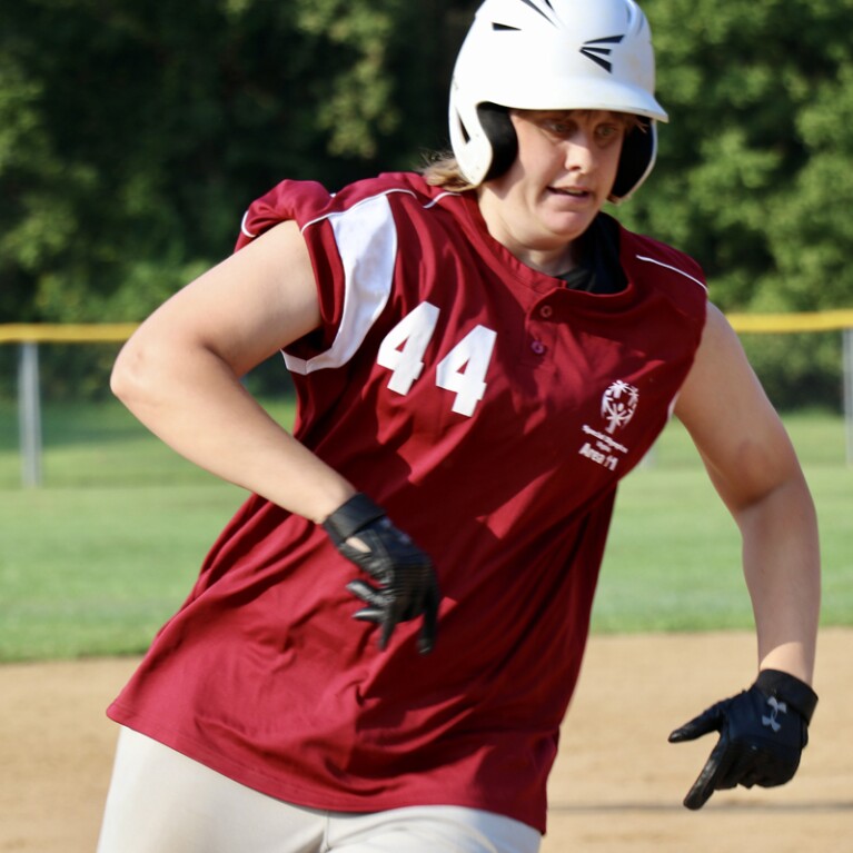 Female softball player running from base to base. 