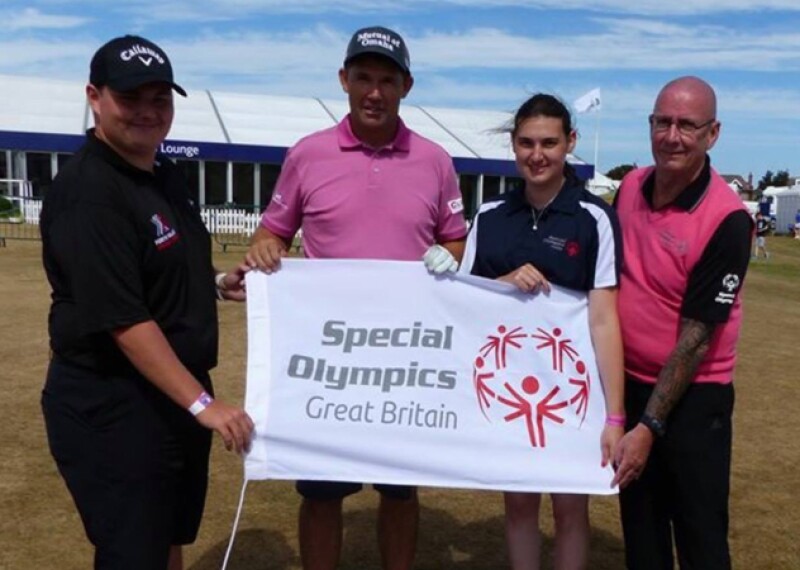 Four people standing out together holding a banner that reads: Special Olympics Great Britain. 