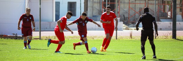 Footballers on the field kicking the ball. 