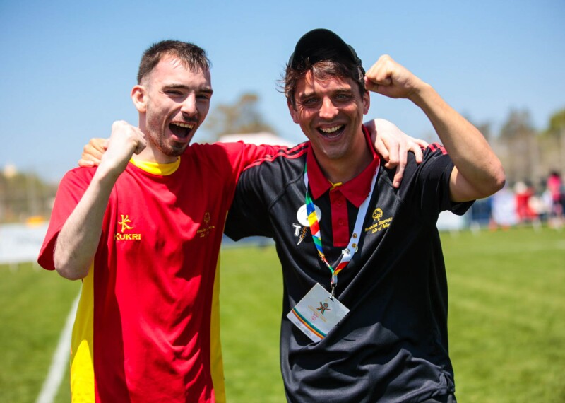 Athlete and coach fist pumping in celebration. 