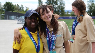 Novie poses alongside one of her competitors. They both have medals around their necks.