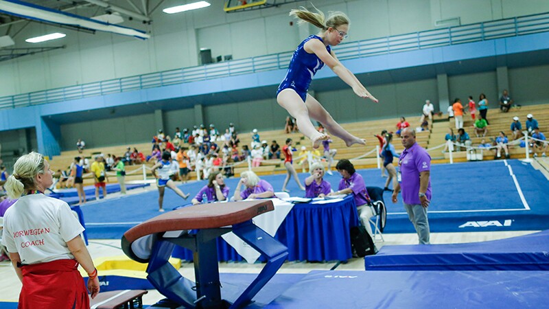 A female gymnast performing on the fault at Special Olympics World Summer Games Los Angeles 2015