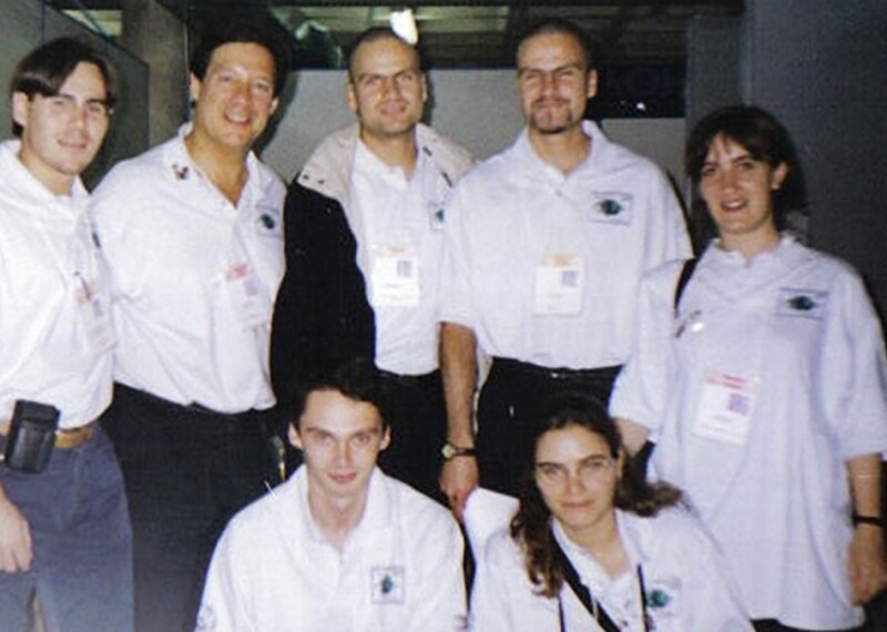 Seven people wearing white jerseys posing for the photo.