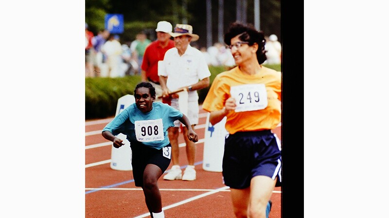 Two athletes running on the track. 