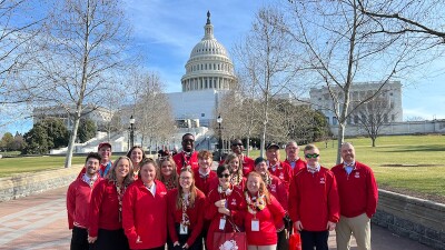 A group of Special Olympics athletes, Unified partners and staff members pose for a photo outside the US Capitol. 