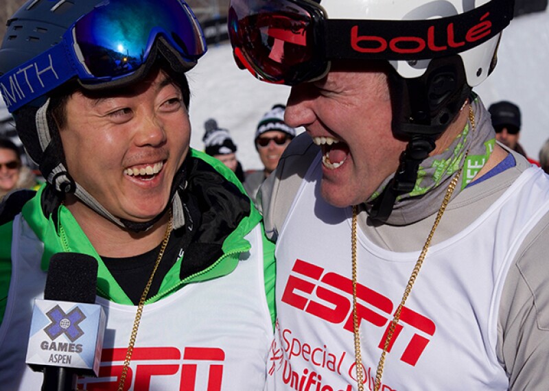 ESPN correspondent interviewing two X-Games snowboarding Unified Athletes. 