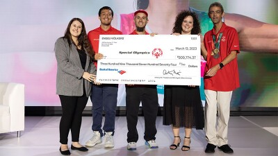 Five people holding a large check. 