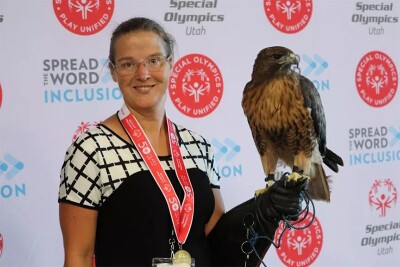 Amber standing for a picture with her red tail hawk