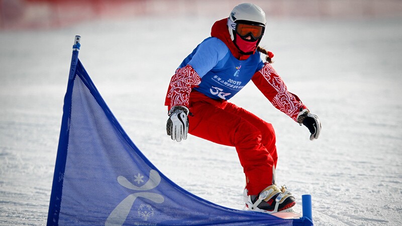 Snowboarder going down the slop in Pyeong Chang Korea. 