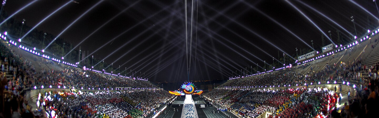 2011 World Game Opening Ceremony at night with bleachers full and a light show in the sky. 