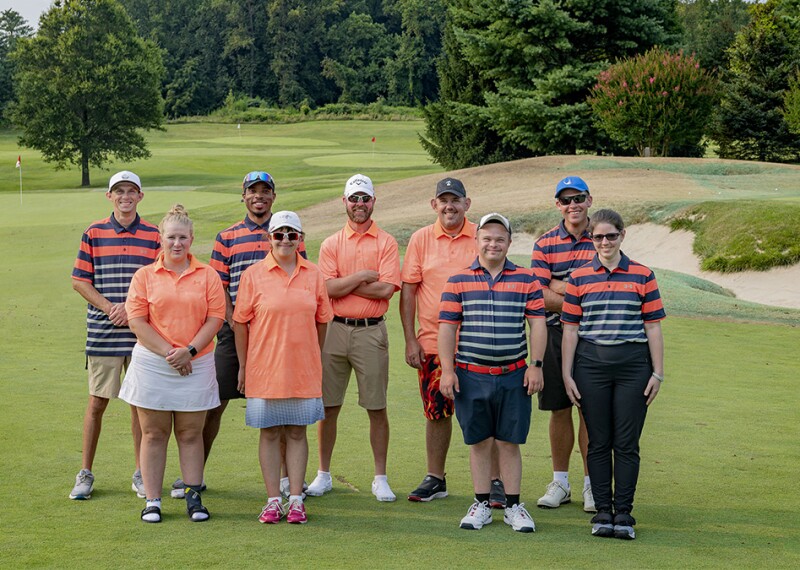 people standing in two rows on golf green