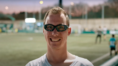 Man in athletic glasses smiling. 