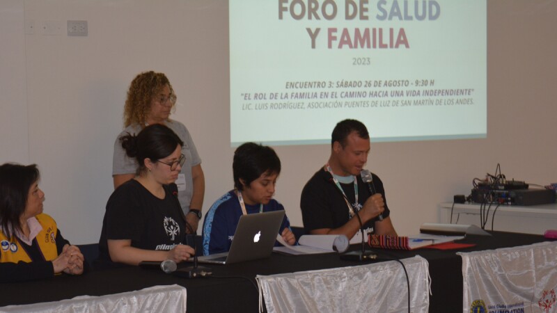 Pablo Composto seated among other panelists in a Family & Health Forum event by Special Olympics Argentina