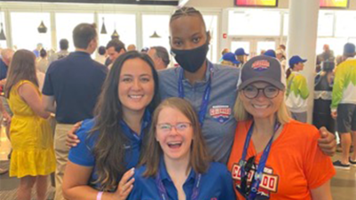 Four people pose for a group photo. 