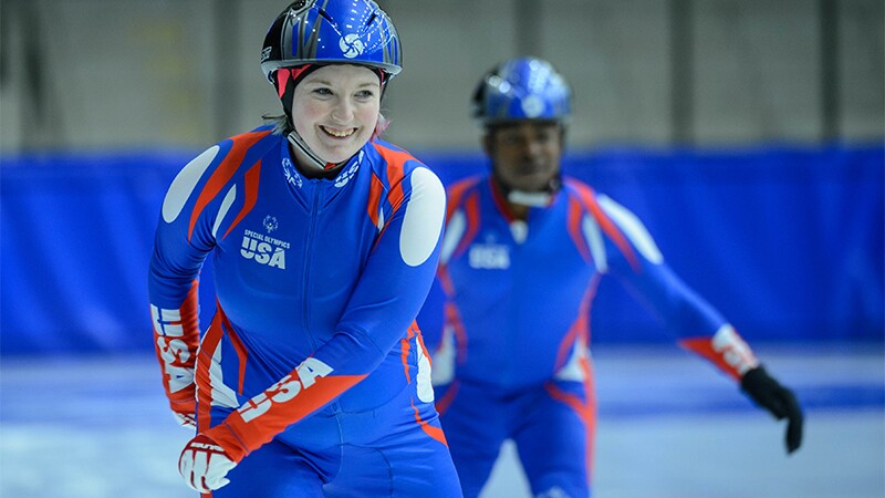 Two athletes on the ice speed skating. 