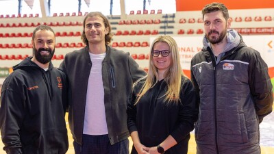 Four people, three men and one woman, standing and posing for the photo