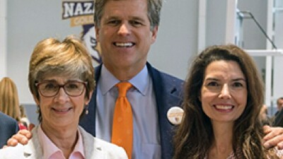 Anne Costello, Dr. Timmothy Shriver, and Dr. Alicia Bazzano standing together. 