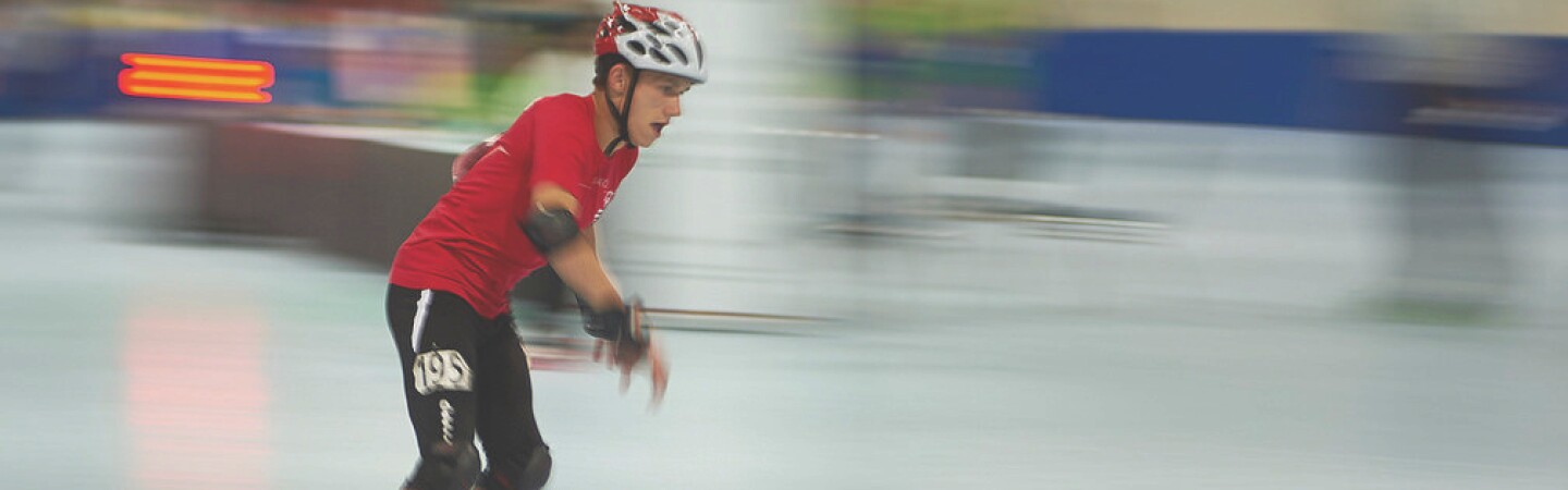 Male athlete rollerblading on the court. 