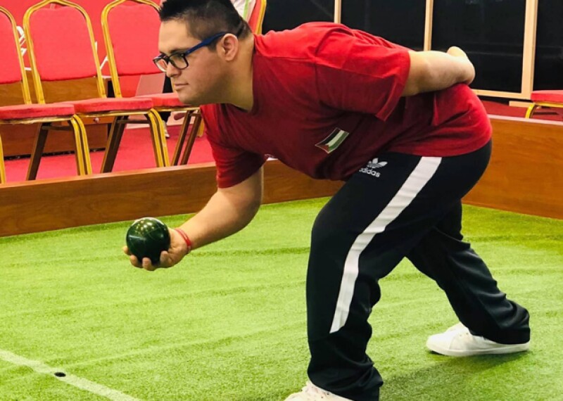 Young man playing bocce. 