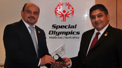 Ayman Wahab and Sherif El Fouly of Special Olympics Middle East North Africa pose in Inclusion Revolution Radio logo.