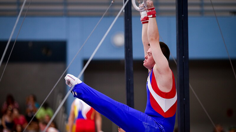 A male gymnast performing on the rings at Special Olympics World Summer Games Los Angeles 2015