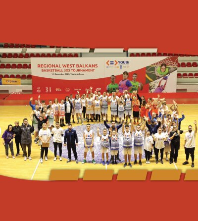 Basketball team standing on the court in a large group. 