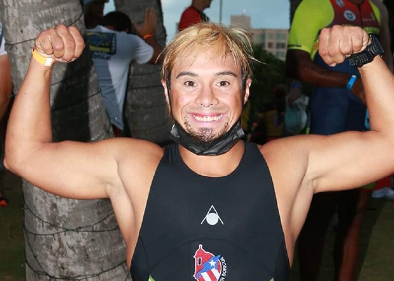 A man rejoices after competing in a triathlon.