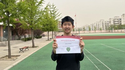 Jianyu proudly displays his leadership certification from Special Olympics 