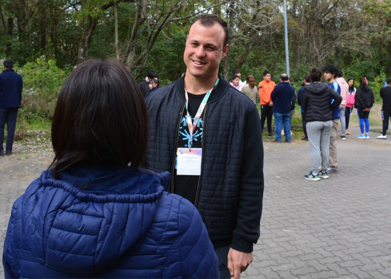 Pablo Composto talks with a woman during a work event