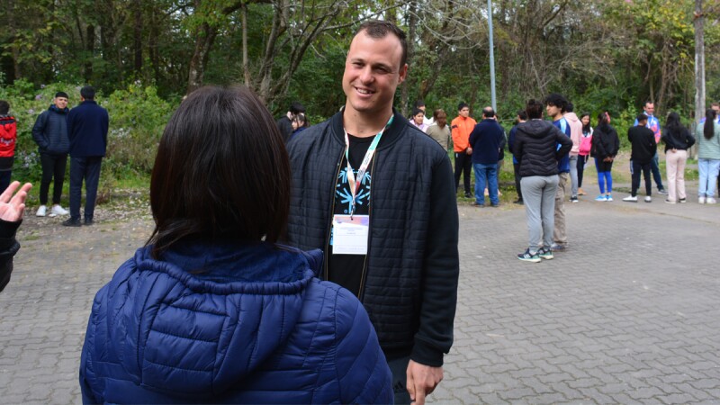 Pablo Composto talks with a woman during a work event