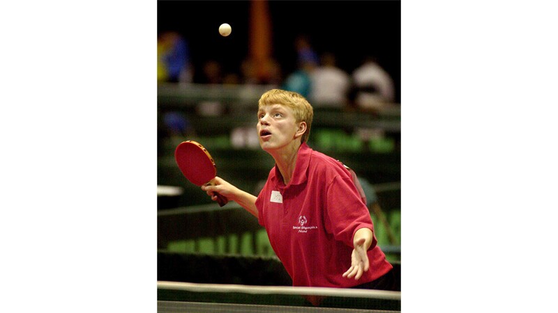 Table tennis athlete prepares to hit the ball. 