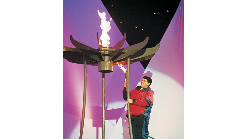 Athlete uses the torch to light the cauldron at the 2001 World Winter Games Alaska Opening Ceremony