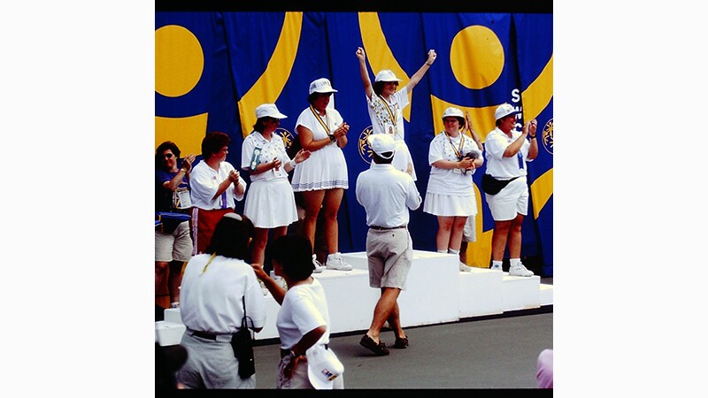 1995 World Games athletes celebrate their win on the podium. 