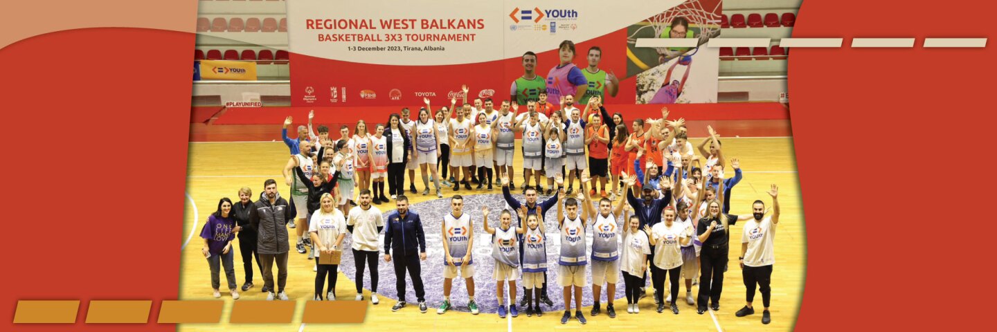 Basketball team standing on the court in a large group. 