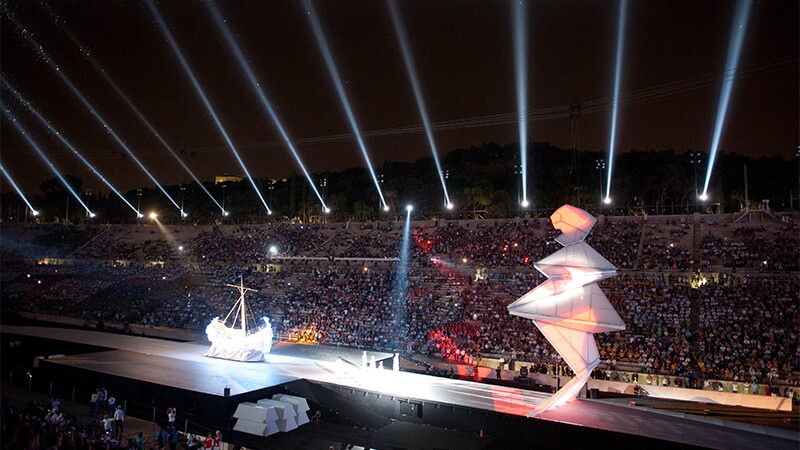 Opening ceremony performance in a stadium full of spectators. 