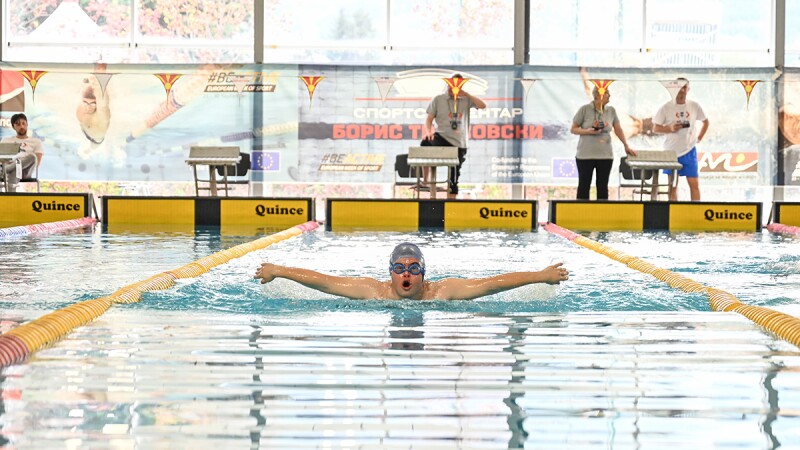 A young man doing the butterfly stroke.