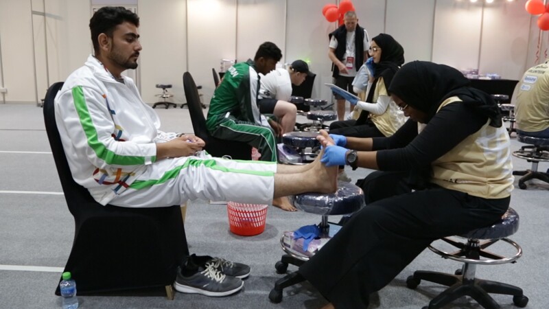 World Games Abu Dhabi 2019: athlete receiving a foot exam at a Healthy Athletes Fit Feet exhibit. 