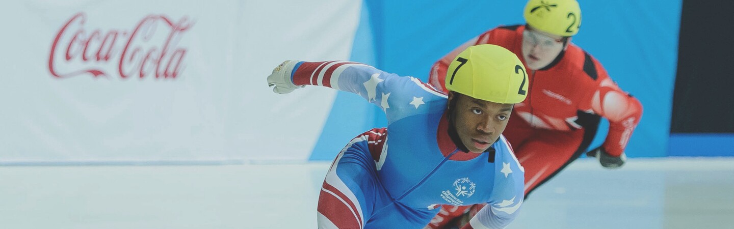 Two athletes racing on a the ice. 